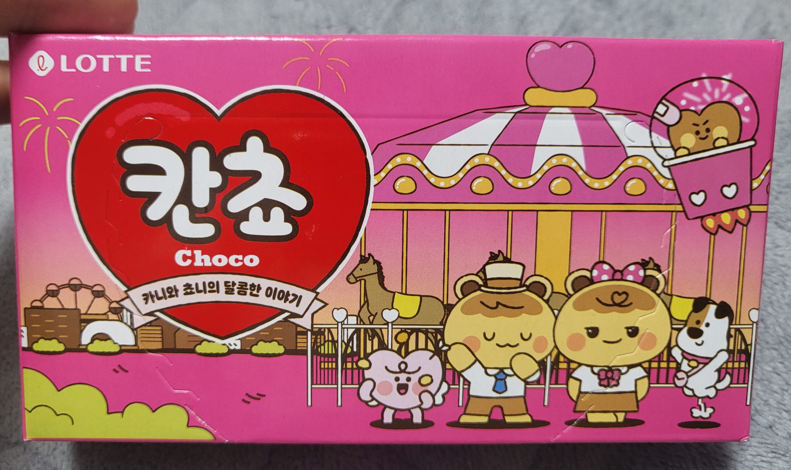 A photo of a Korean chocolate snack box called Kancho, featuring the Kancho characters Kani and Choni riding a Viking ship ride.